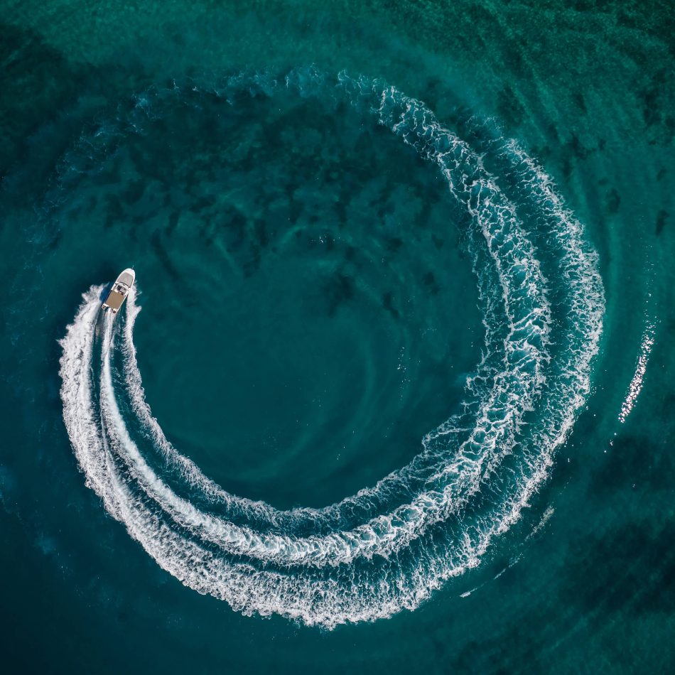Boat creating a circular ripple in water
