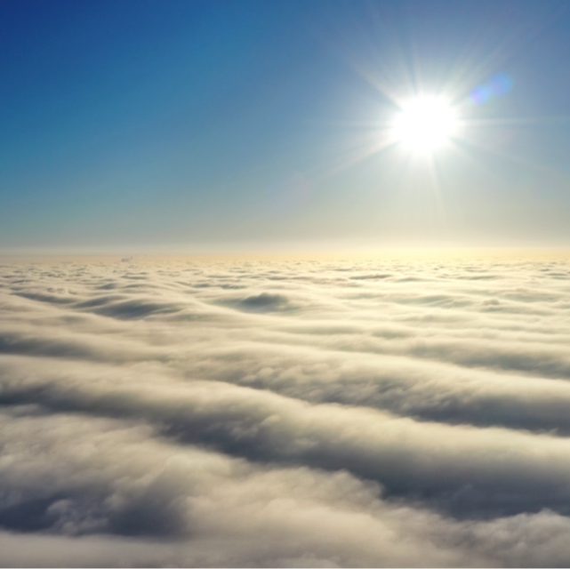 On top of clouds looking at the sun